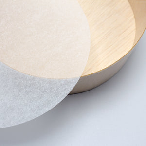 スライドショーWashi feel translucent round piece of paper next to round wood container.の画像を開く
